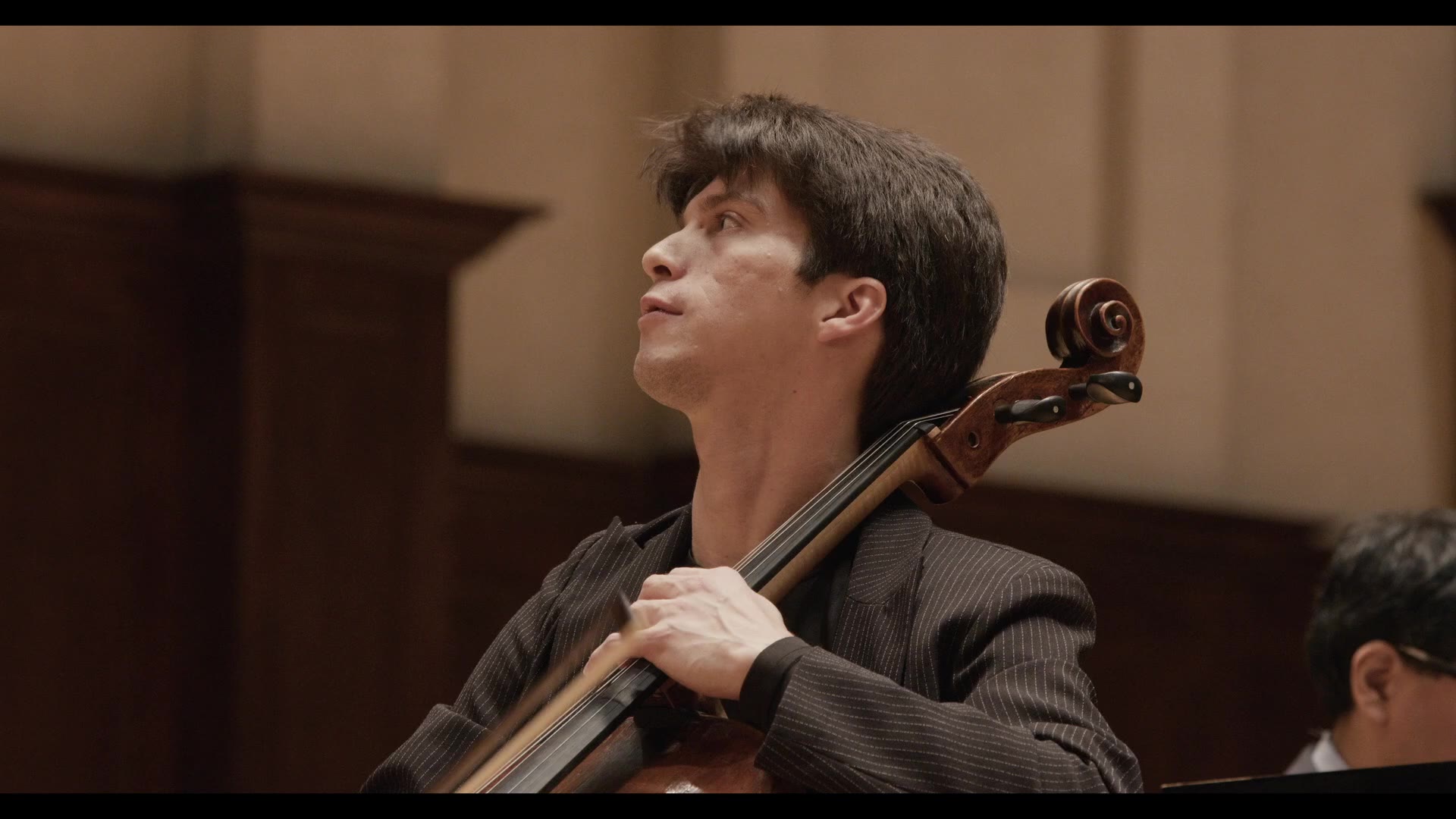 Sphinx Competition performance — cellist mid-performance under stage light