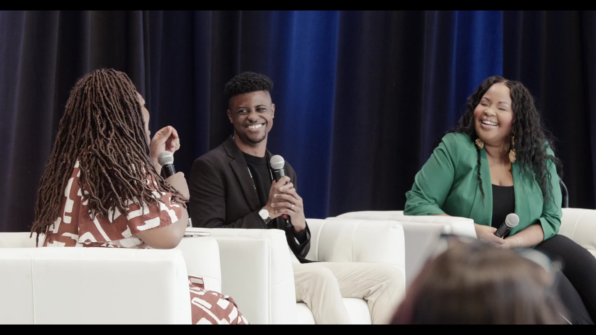 SphinxConnect panel — three speakers on a conference stage